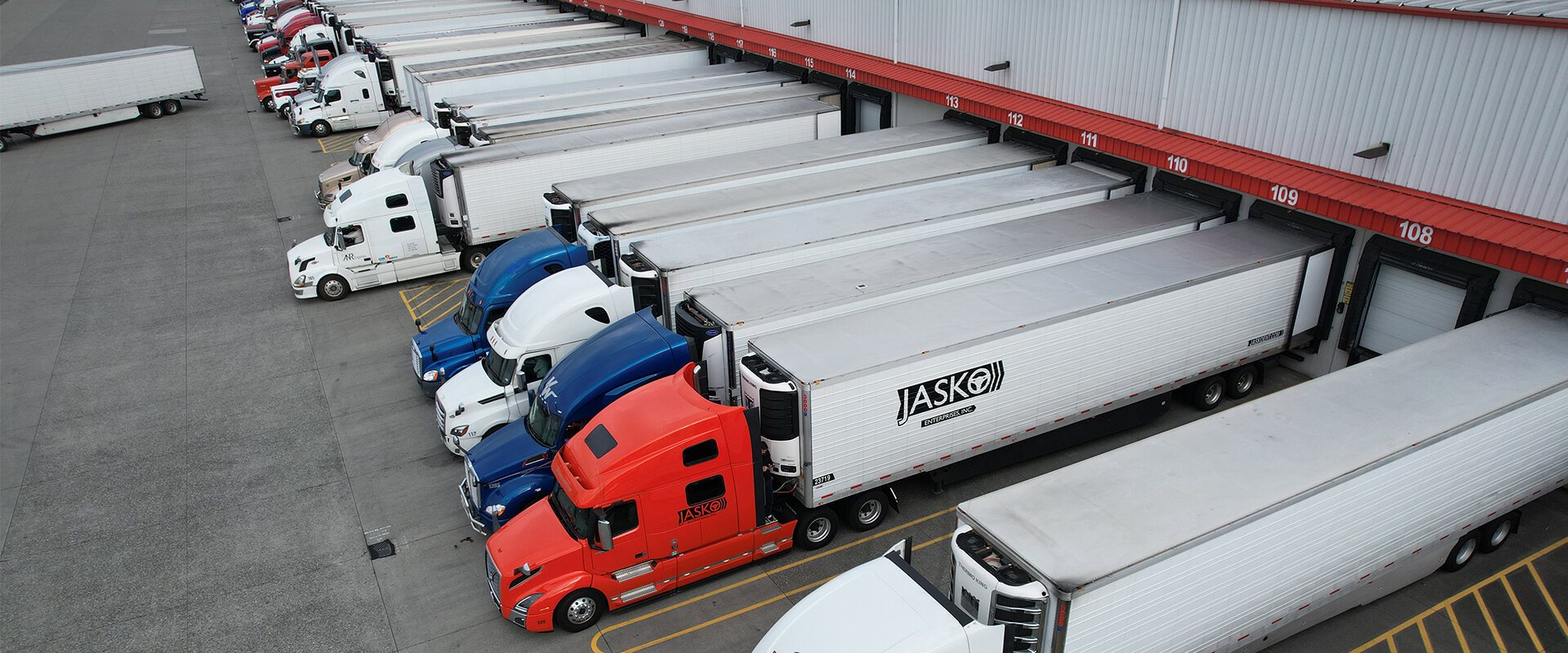 JASKO refrigerated trucks lined up at a distribution facility