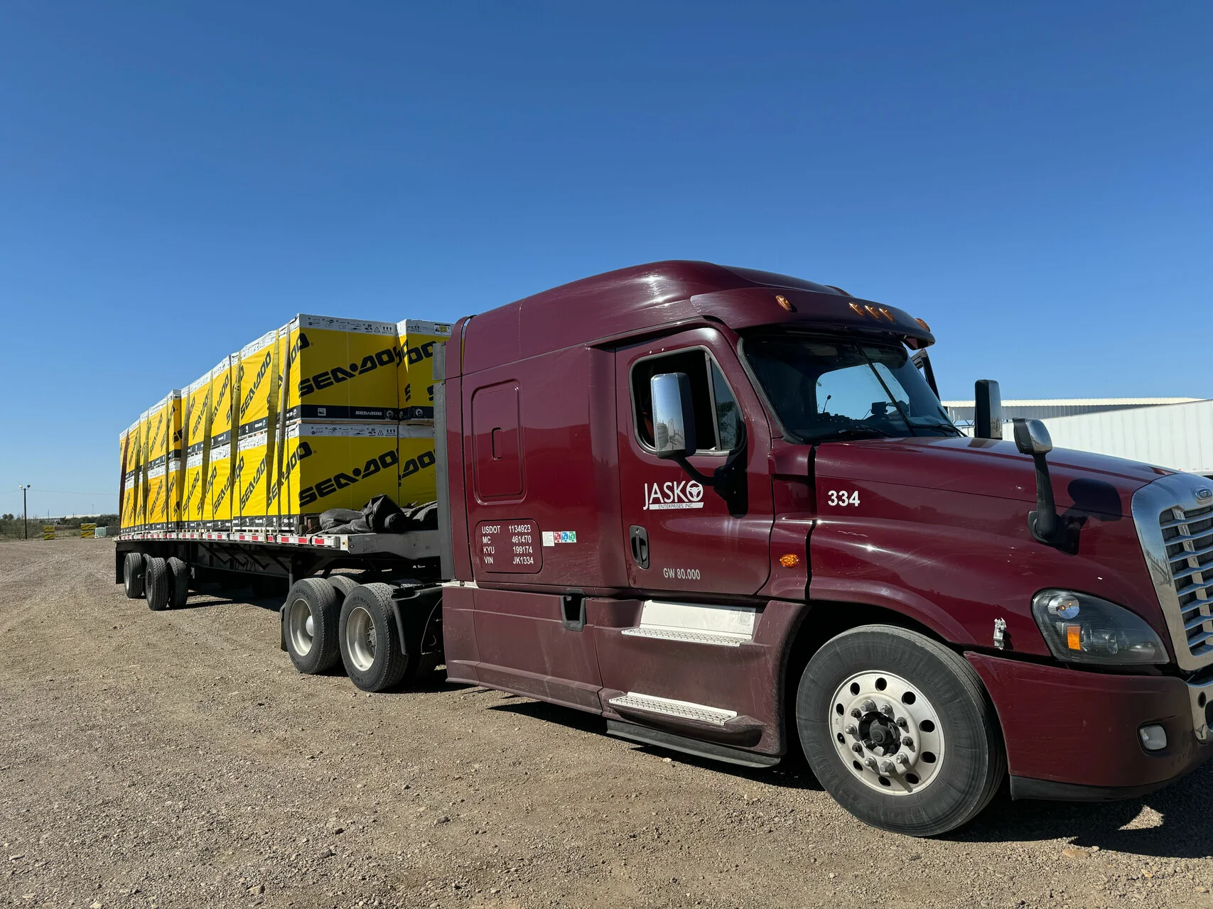JASKO flatbed carrying secured packaged cargo