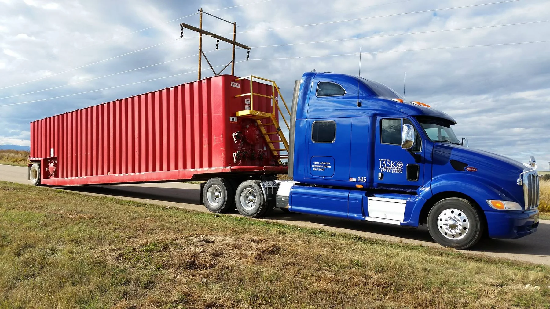 JASKO tractor moving specialized container equipment